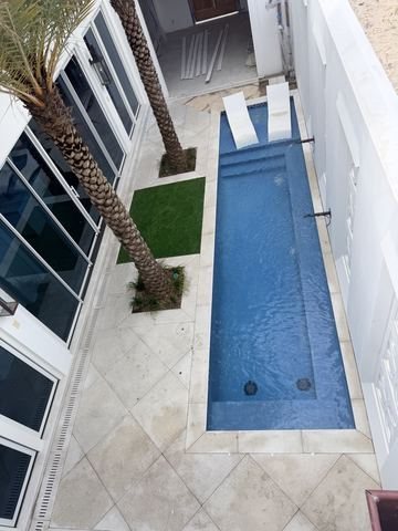 Travertine pool deck and pool pavers installed by Fénix Paver Landscape, 30A FL